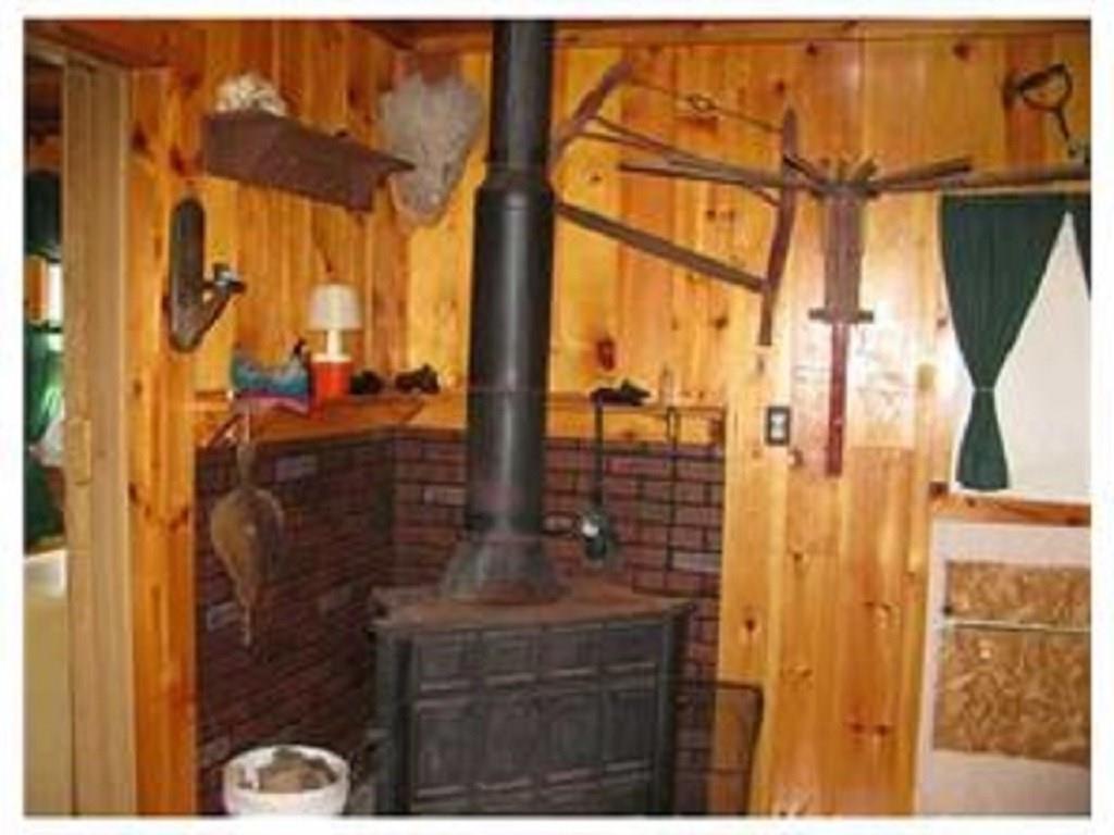 222 Mattamiscontis Road Howland, ME 04448 - Photo 9 of 15 Wood stove to help keep the cabin...