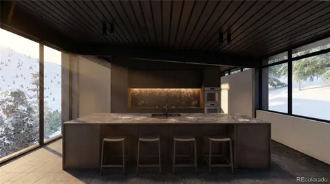 a kitchen with granite countertop a sink a counter top space and cabinets