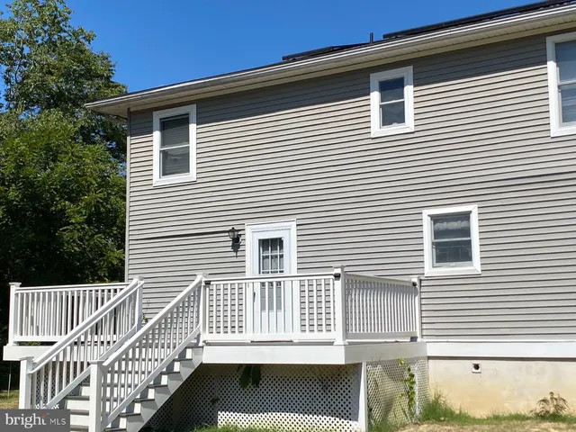 a view of a house with a small deck