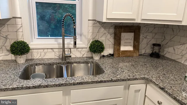 a kitchen with granite countertop a sink and granite counter tops