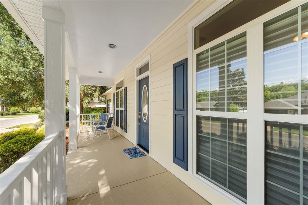 7418 White Oaks Road Alachua, FL 32615 - Photo 2 of 46 a balcony with table and chairs