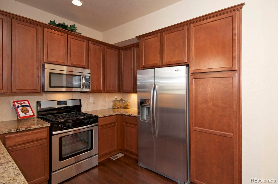 10296 Bellwether Lane Lone Tree, CO 80124 - Photo 11 of 29 a kitchen with a refrigerator stove and microwave