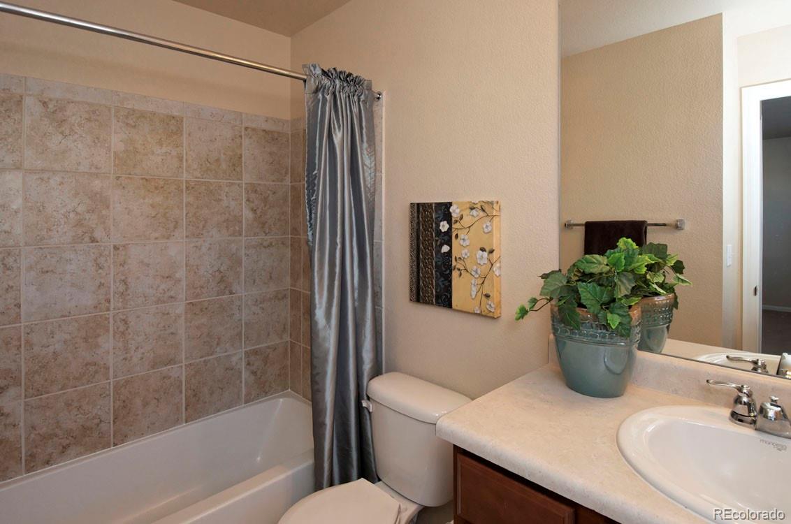 10296 Bellwether Lane Lone Tree, CO 80124 - Photo 16 of 29 a bathroom with a sink toilet and shower