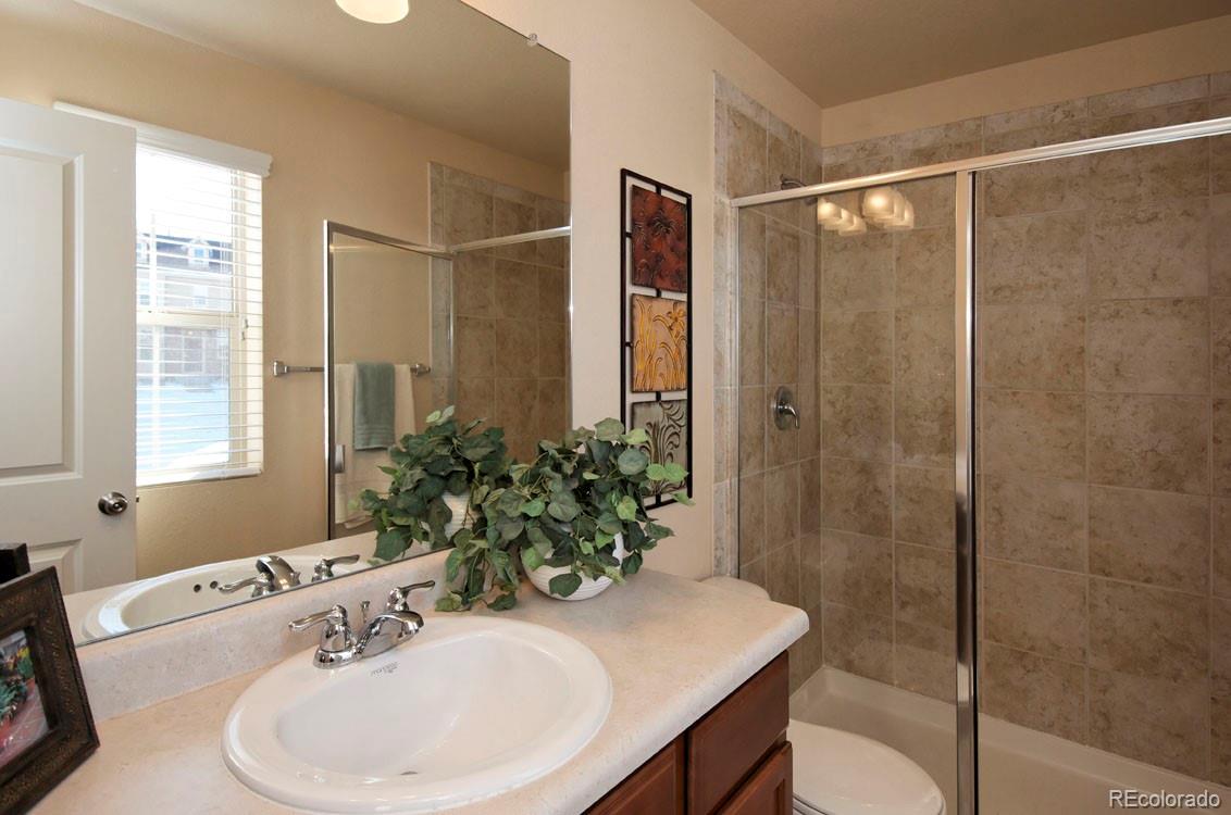 10296 Bellwether Lane Lone Tree, CO 80124 - Photo 20 of 29 a bathroom with a sink and a mirror