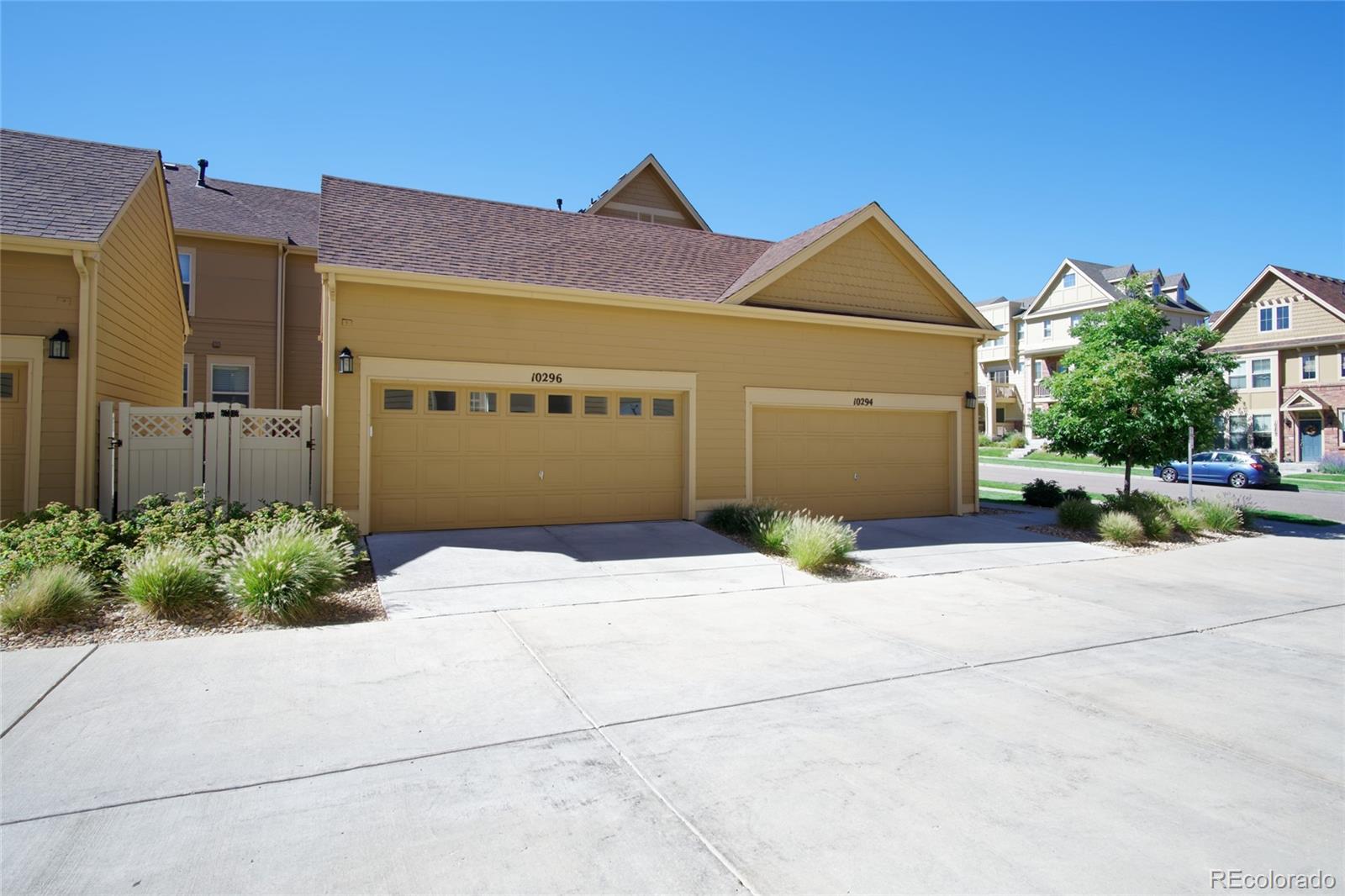 10296 Bellwether Lane Lone Tree, CO 80124 - Photo 23 of 29 a front view of a house with a yard and garage