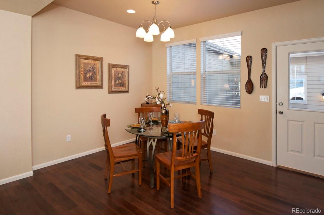 10296 Bellwether Lane Lone Tree, CO 80124 - Photo 6 of 29 a view of a dining room with furniture and wooden floor