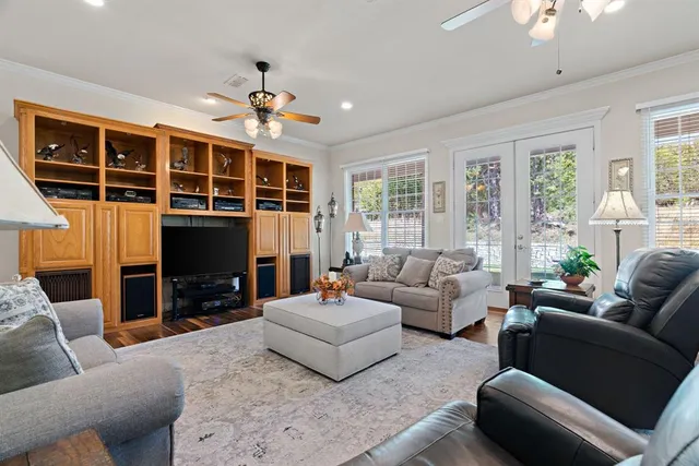 a living room with furniture fireplace and a large window