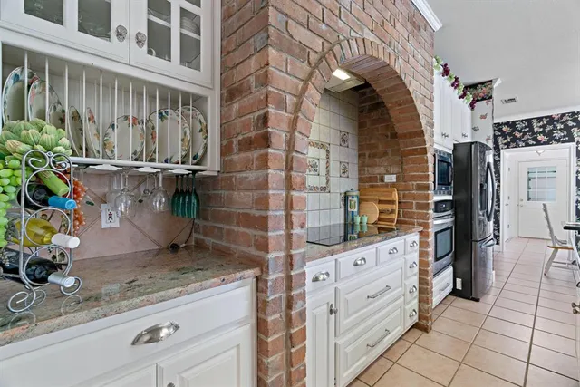 a kitchen with granite countertop a sink and a counter top space