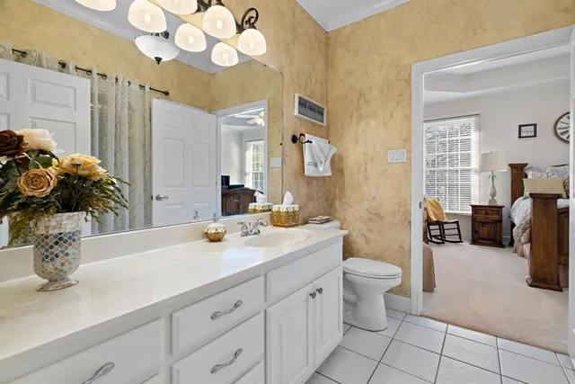 a spacious bedroom with a bed and a flat screen tv