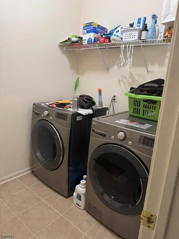a spacious bedroom with a bed a chandelier and couch