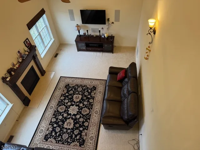a bedroom with a bed and a flat tv screen on the dresser