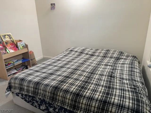 a bedroom with a bed and dresser