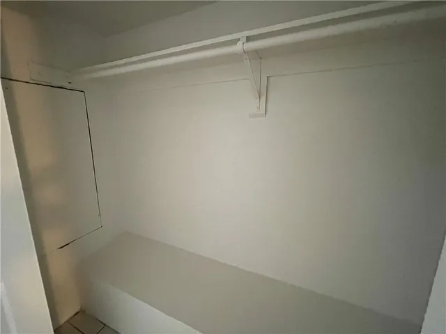 a bedroom with a bed and painting on the wall