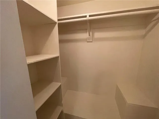 a kitchen with white cabinets a sink and appliances