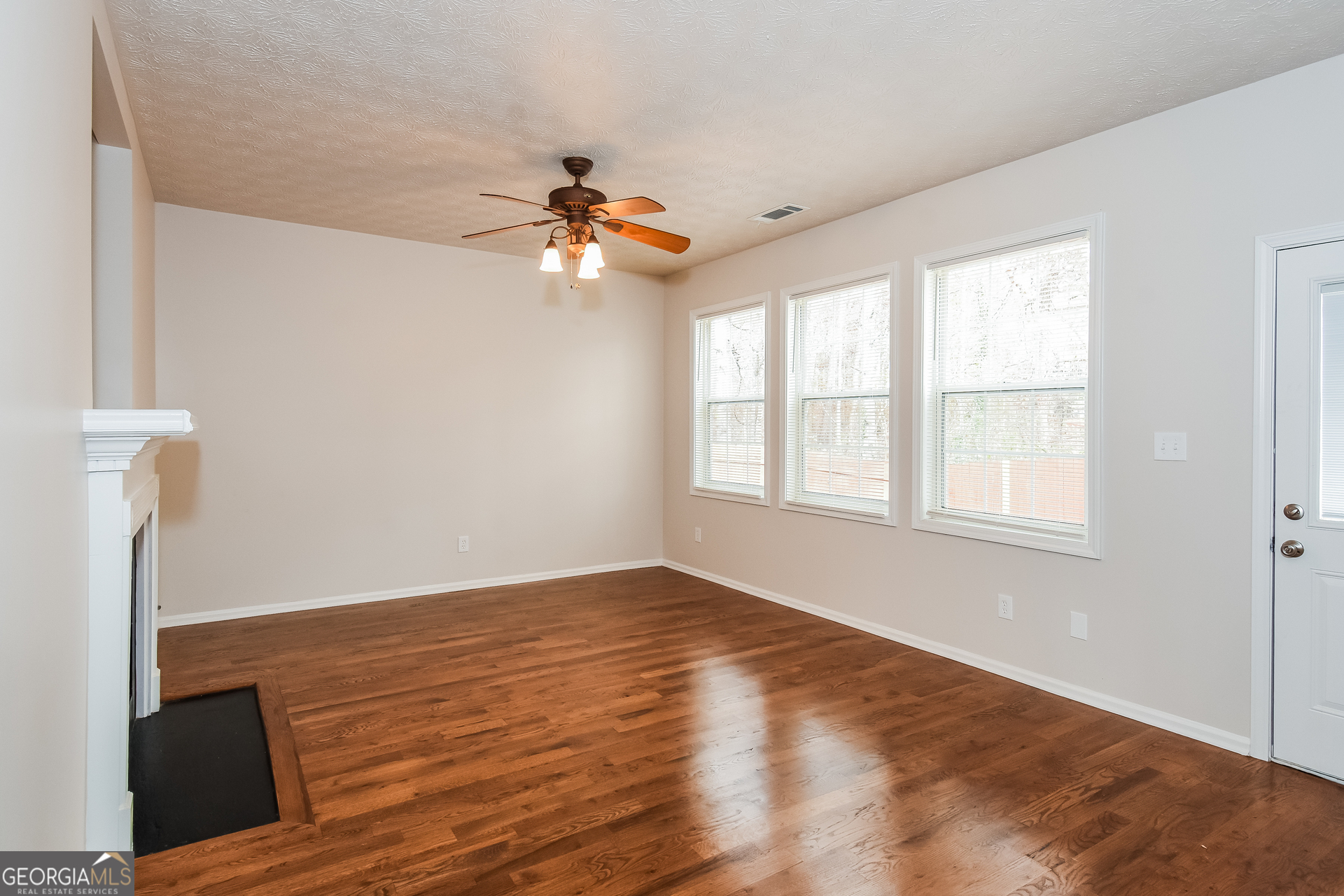 343 Alderman Trace Southwest Austell, GA 30168 - Photo 2 of 17 a view of empty room with wooden floor and fan
