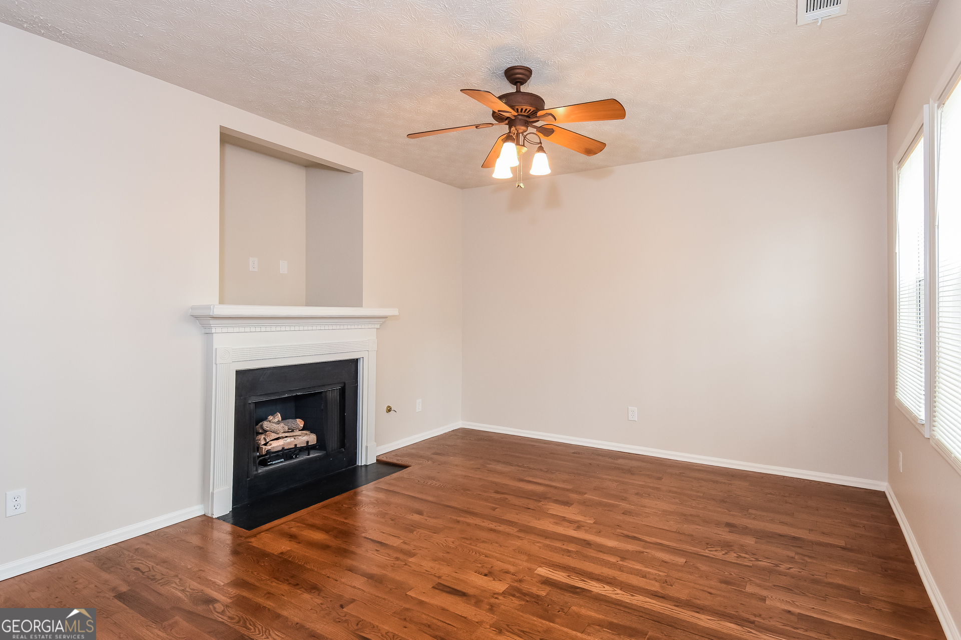 343 Alderman Trace Southwest Austell, GA 30168 - Photo 4 of 17 a view of empty room with wooden floor and fireplace