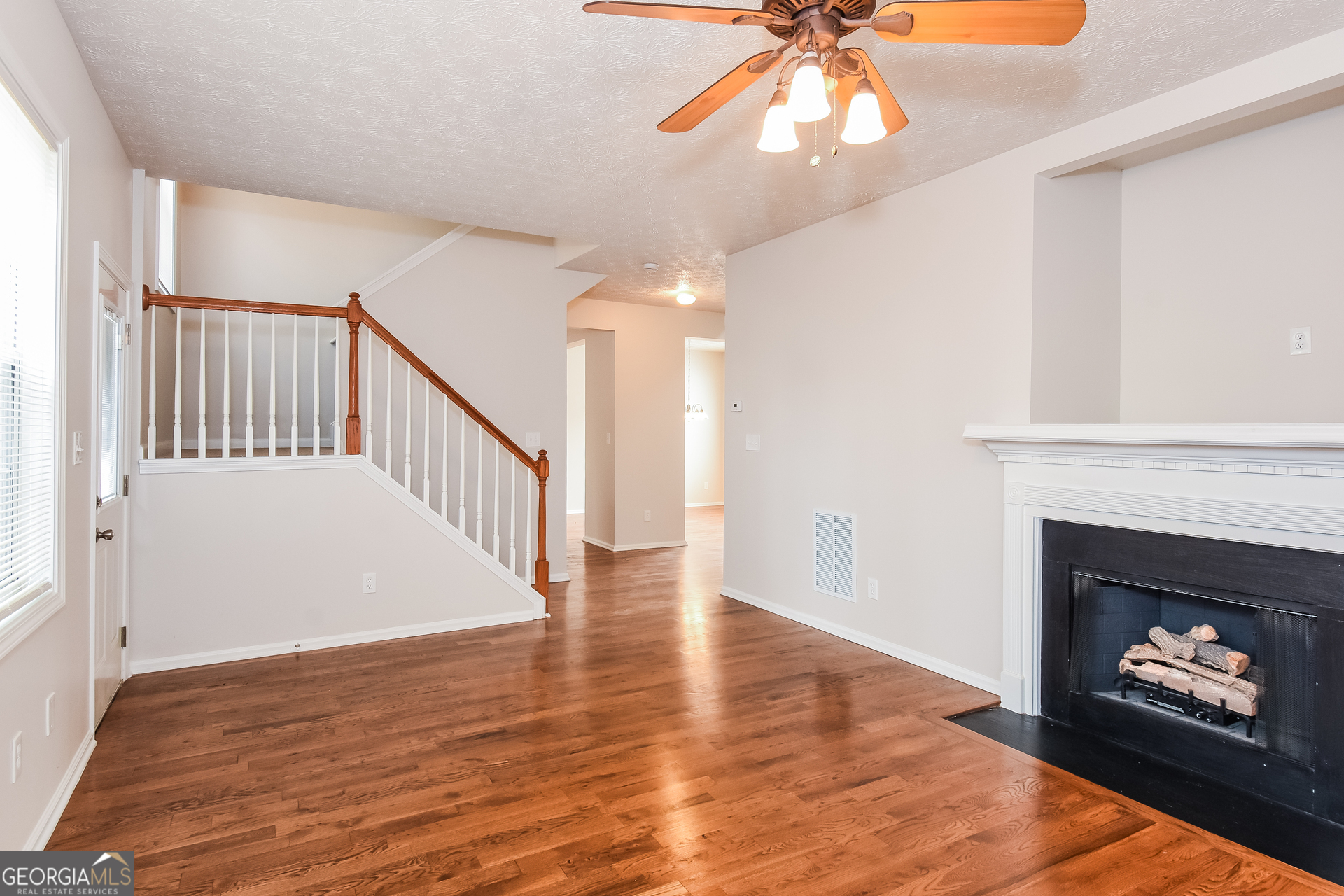 343 Alderman Trace Southwest Austell, GA 30168 - Photo 5 of 17 a view of an empty room with chandelier fan and fire place
