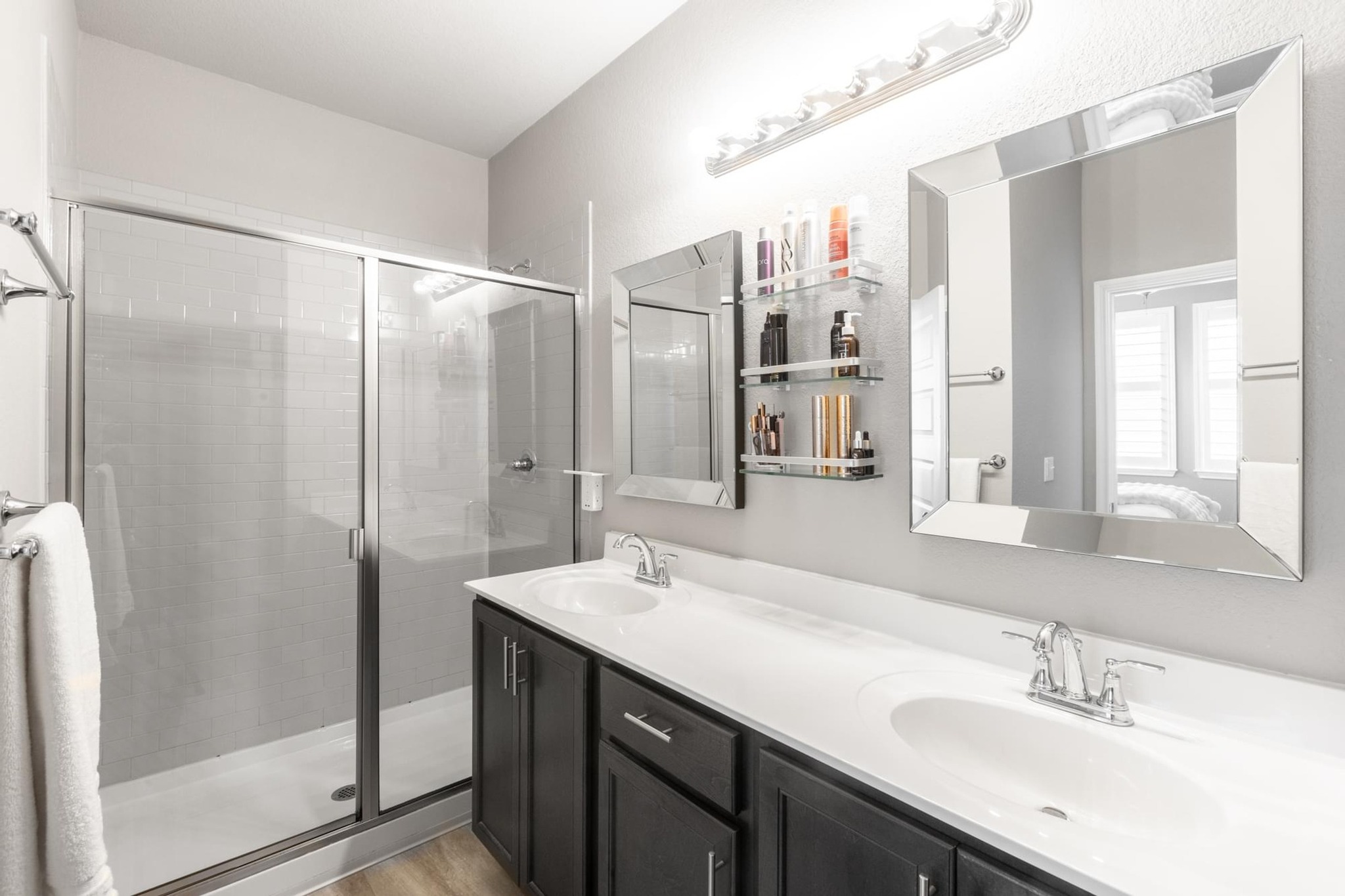 7801 Frida Bend Austin, TX 78744 - Photo 24 of 26 Dual vanities and a spacious glass-enclosed shower create a rejuvenating bathing space.