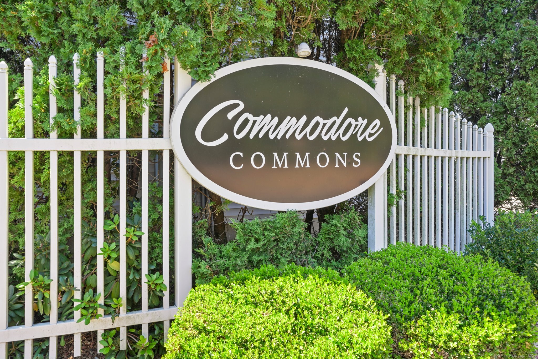 49 Commodore Cmns, Unit 49 Derby, CT 06418 - Photo 1 of 1 a view of outdoor space with signage and flags