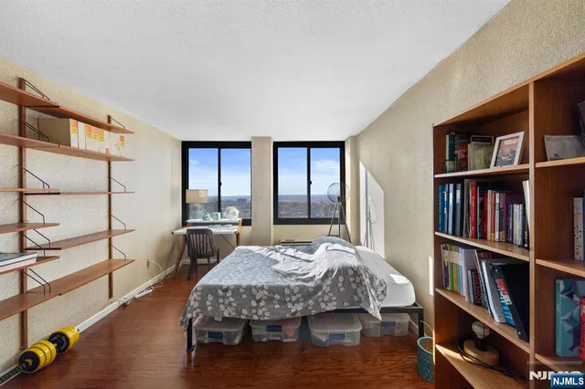 a bedroom with a bed furniture and a book shelf