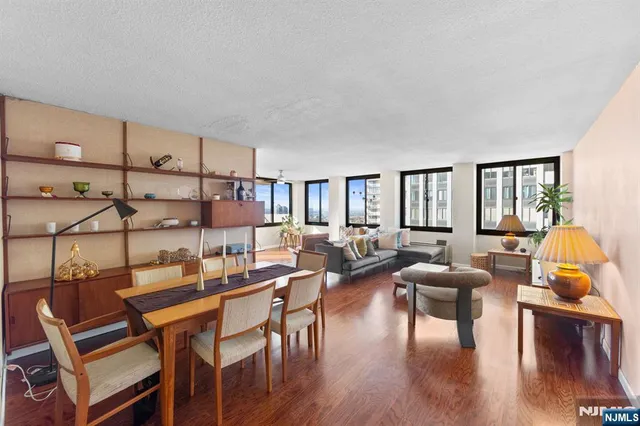 a living room with lots of furniture and wooden floor