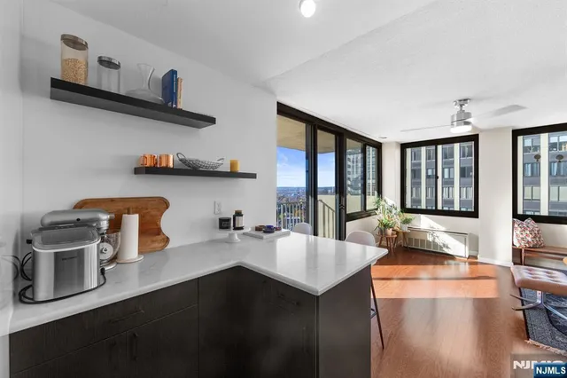 a kitchen with a sink a stove and chairs