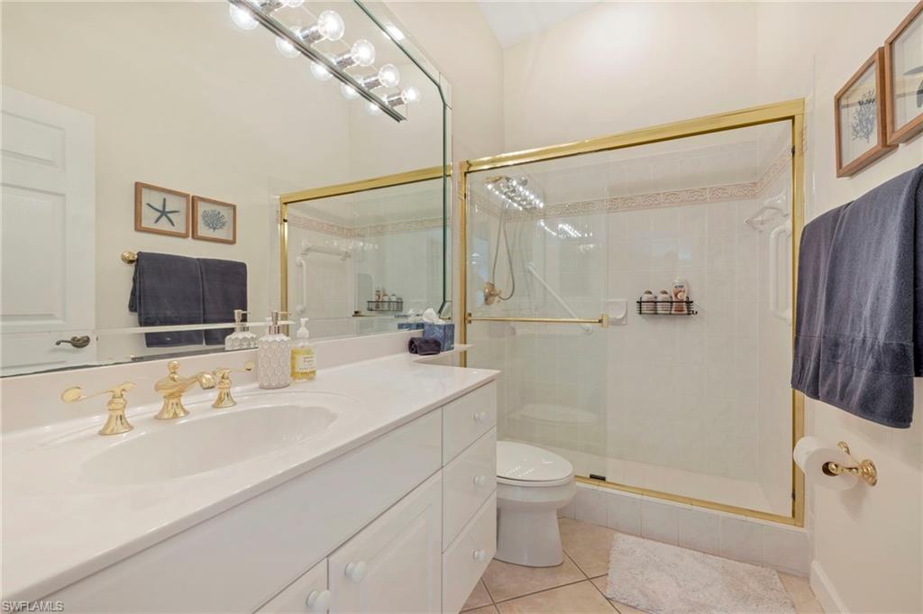 14530 Red Fox Run, Unit 204 Naples, FL 34110 - Photo 13 of 18 a bathroom with a bathtub shower sink vanity and toilet