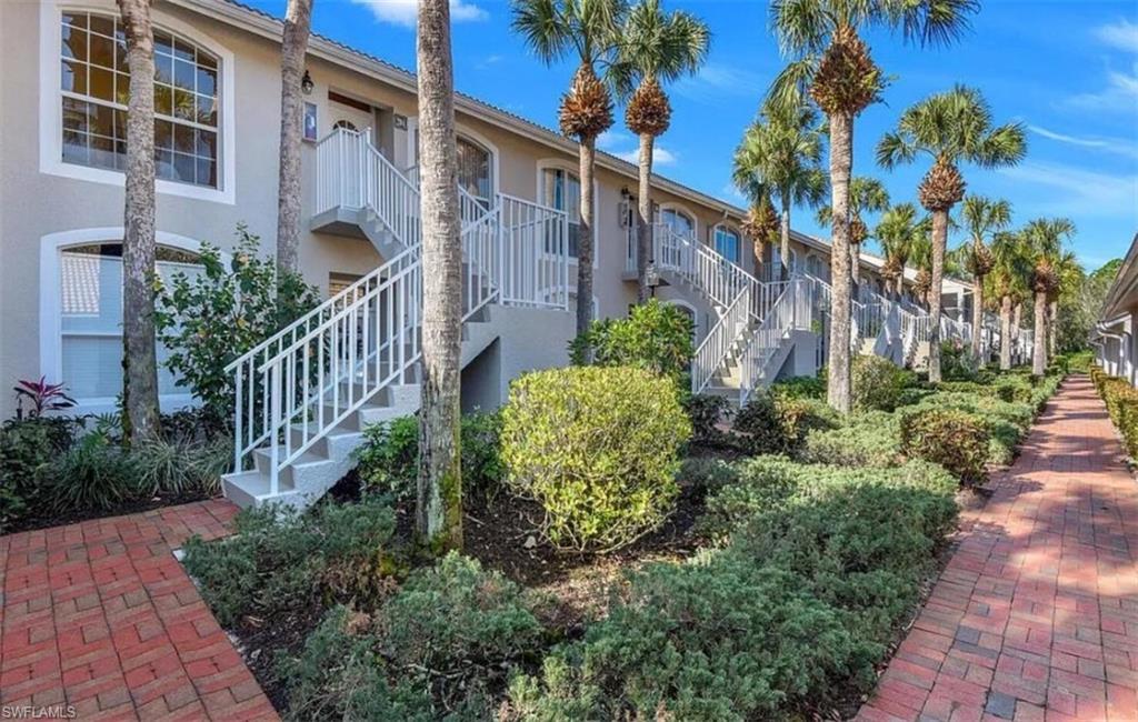 14530 Red Fox Run, Unit 204 Naples, FL 34110 - Photo 15 of 18 a view of a garden with brick house