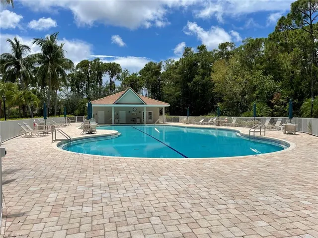 a view of a swimming pool with a yard