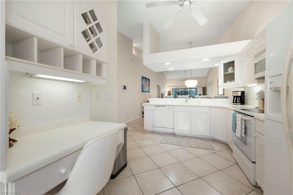 14530 Red Fox Run, Unit 204 Naples, FL 34110 - Photo 2 of 18 a kitchen with a sink a stove cabinets and white appliances