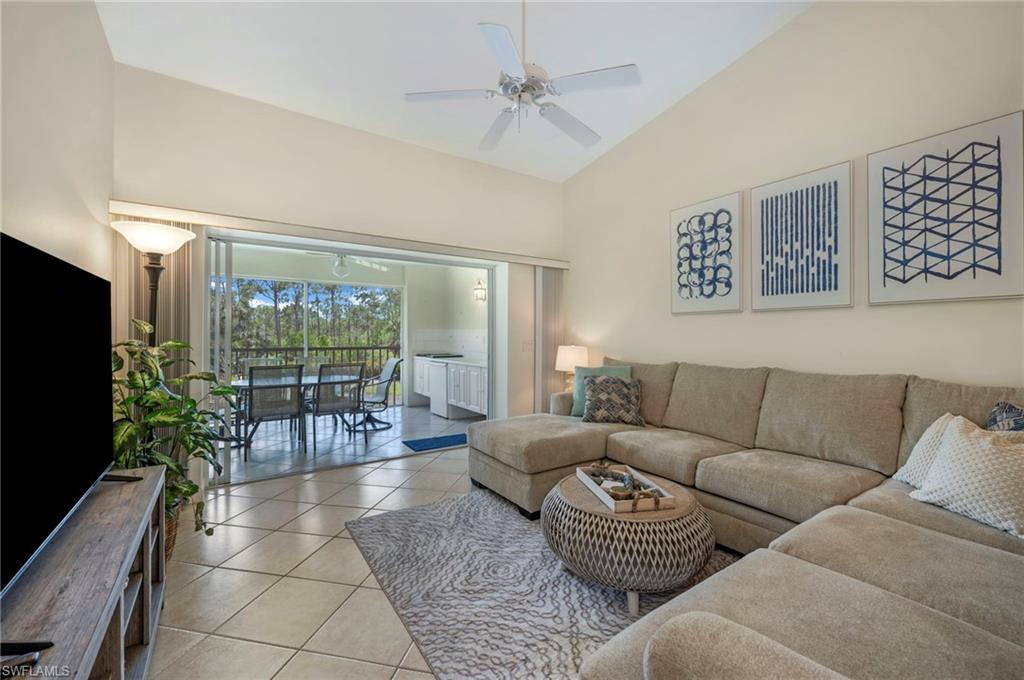 14530 Red Fox Run, Unit 204 Naples, FL 34110 - Photo 6 of 18 a living room with furniture and a flat screen tv