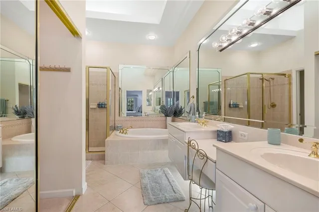 a spacious bathroom with a tub sink shower and mirror
