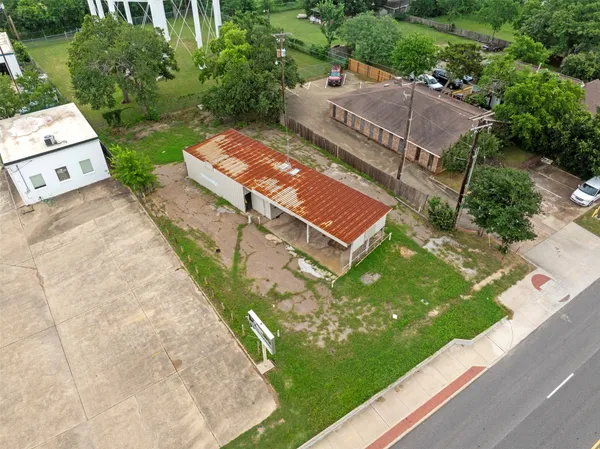 an aerial view of a house with garden space and street view
