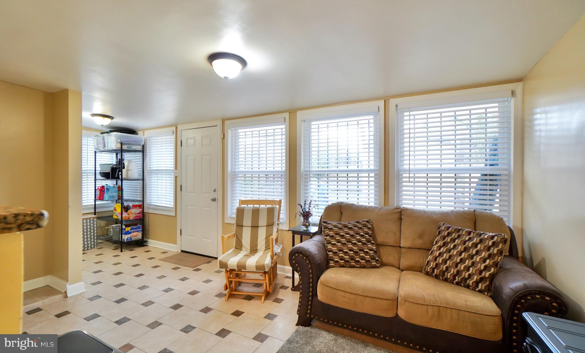 7767 Muncy Road Landover, MD 20785 - Photo 14 of 27 a living room with furniture and a floor to ceiling window