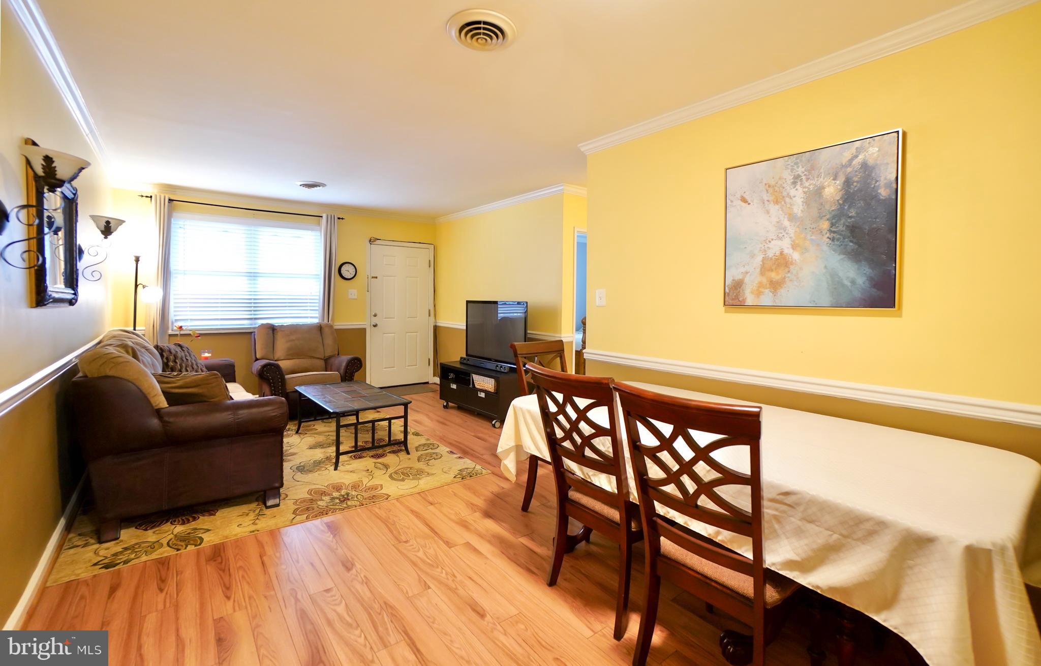7767 Muncy Road Landover, MD 20785 - Photo 3 of 27 a living room with furniture and a wooden floor