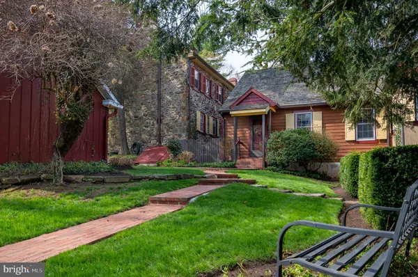 a front view of a house with a yard table and chairs