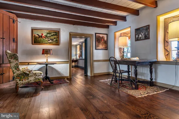 a view of a livingroom with wooden floor and a fireplace