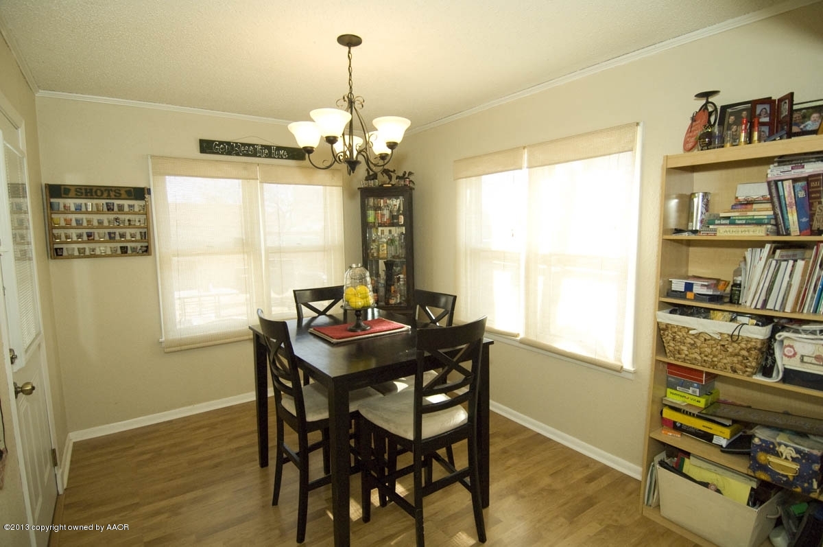 4227 South Jackson Street Amarillo, TX 79110 - Photo 12 of 23 a view of a dining room with furniture window and wooden floor