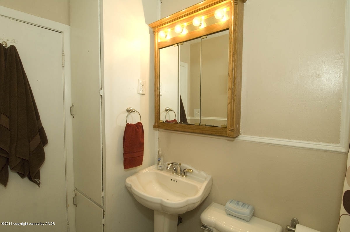 4227 South Jackson Street Amarillo, TX 79110 - Photo 16 of 23 a bathroom with a sink and a mirror