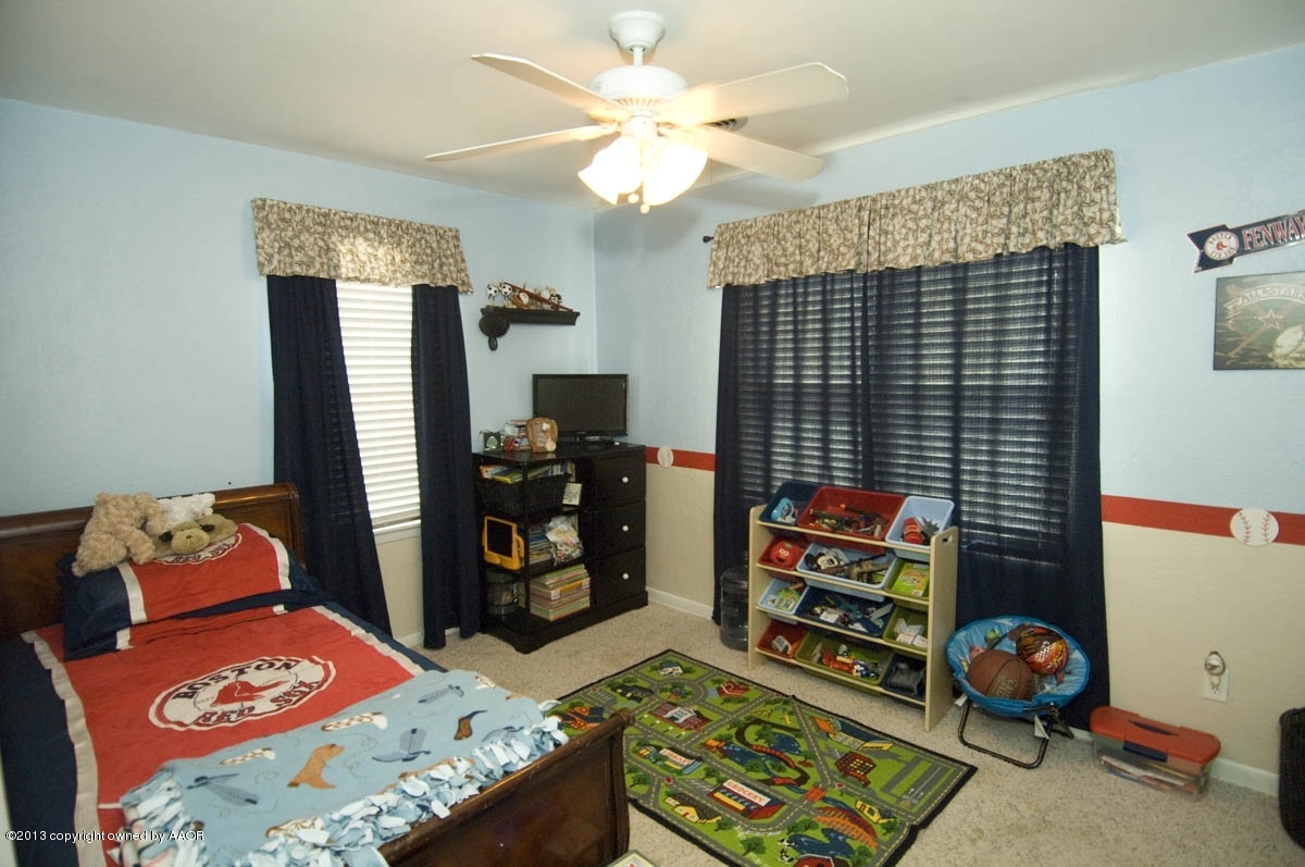 4227 South Jackson Street Amarillo, TX 79110 - Photo 17 of 23 a bedroom with baby bed toys and dresser