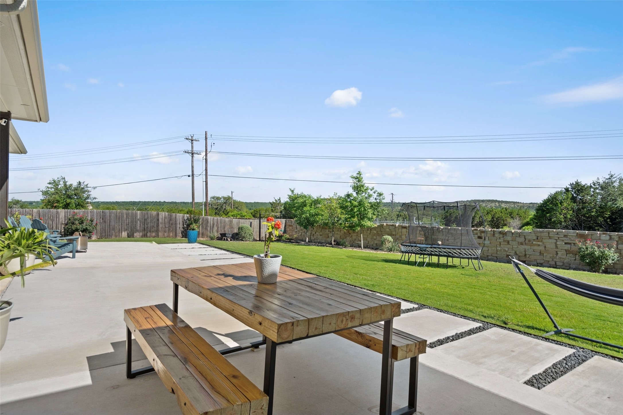 162 Lunar Loop Austin, TX 78737 - Photo 28 of 40 a view of a terrace with a table and chairs