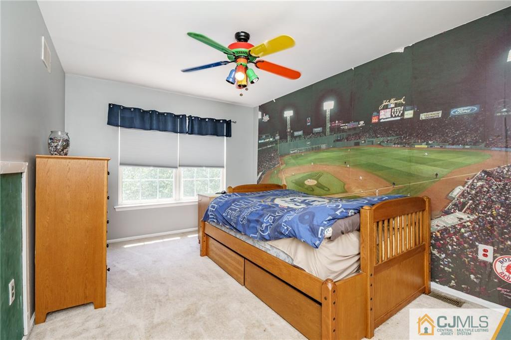 3 Sun Hollow Road Howell, NJ 07731 - Photo 22 of 36 a living room with a bed and a chandelier