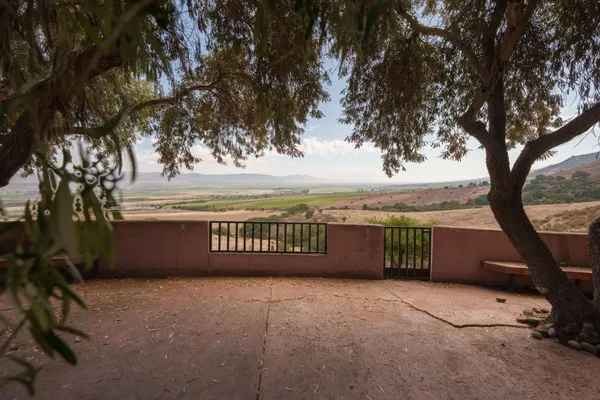 a view of balcony with outdoor space and trees