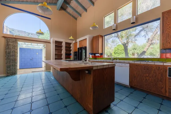 a kitchen with stainless steel appliances granite countertop a sink counter space and a large window