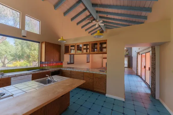 a kitchen with a sink window and cabinets