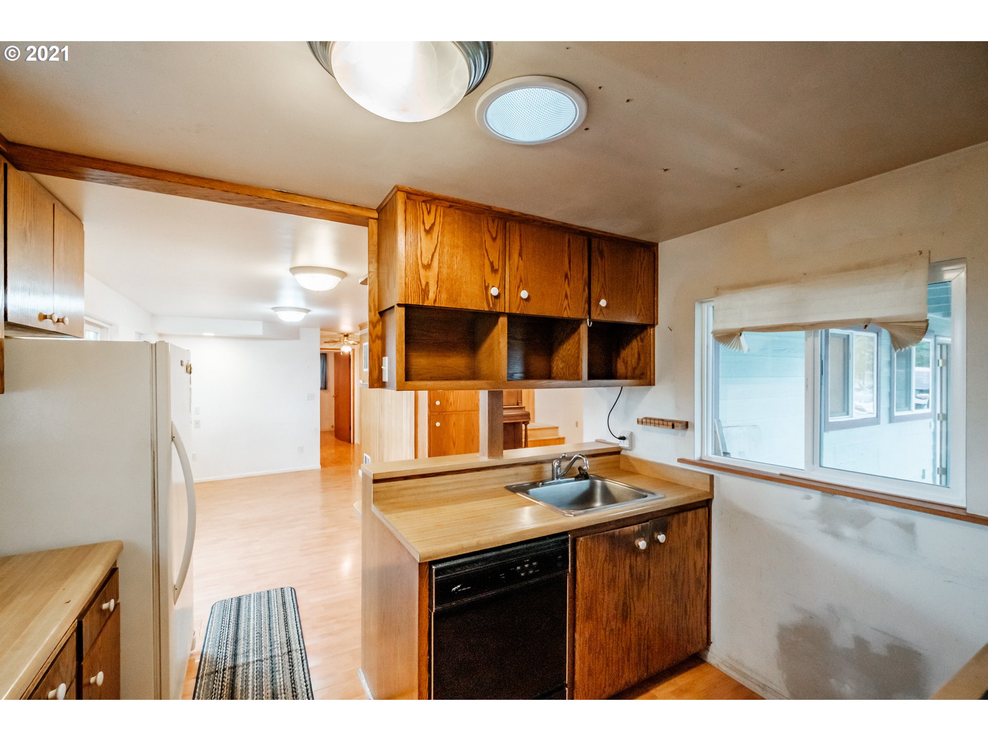 1005 Cascade Drive Lebanon, OR 97355 - Photo 11 of 32 a kitchen with stainless steel appliances a sink and a refrigerator