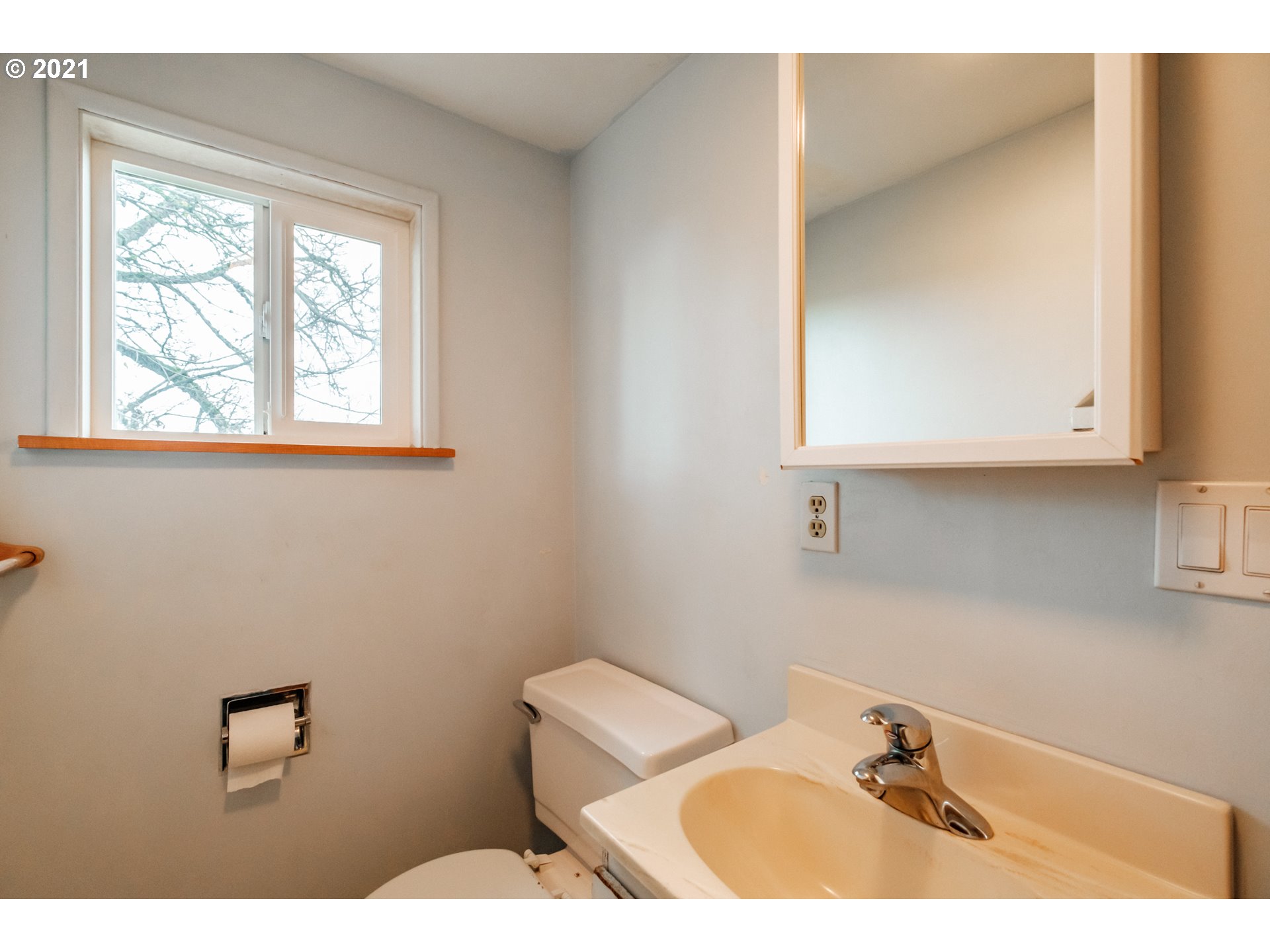 1005 Cascade Drive Lebanon, OR 97355 - Photo 22 of 32 a bathroom with a sink mirror and vanity