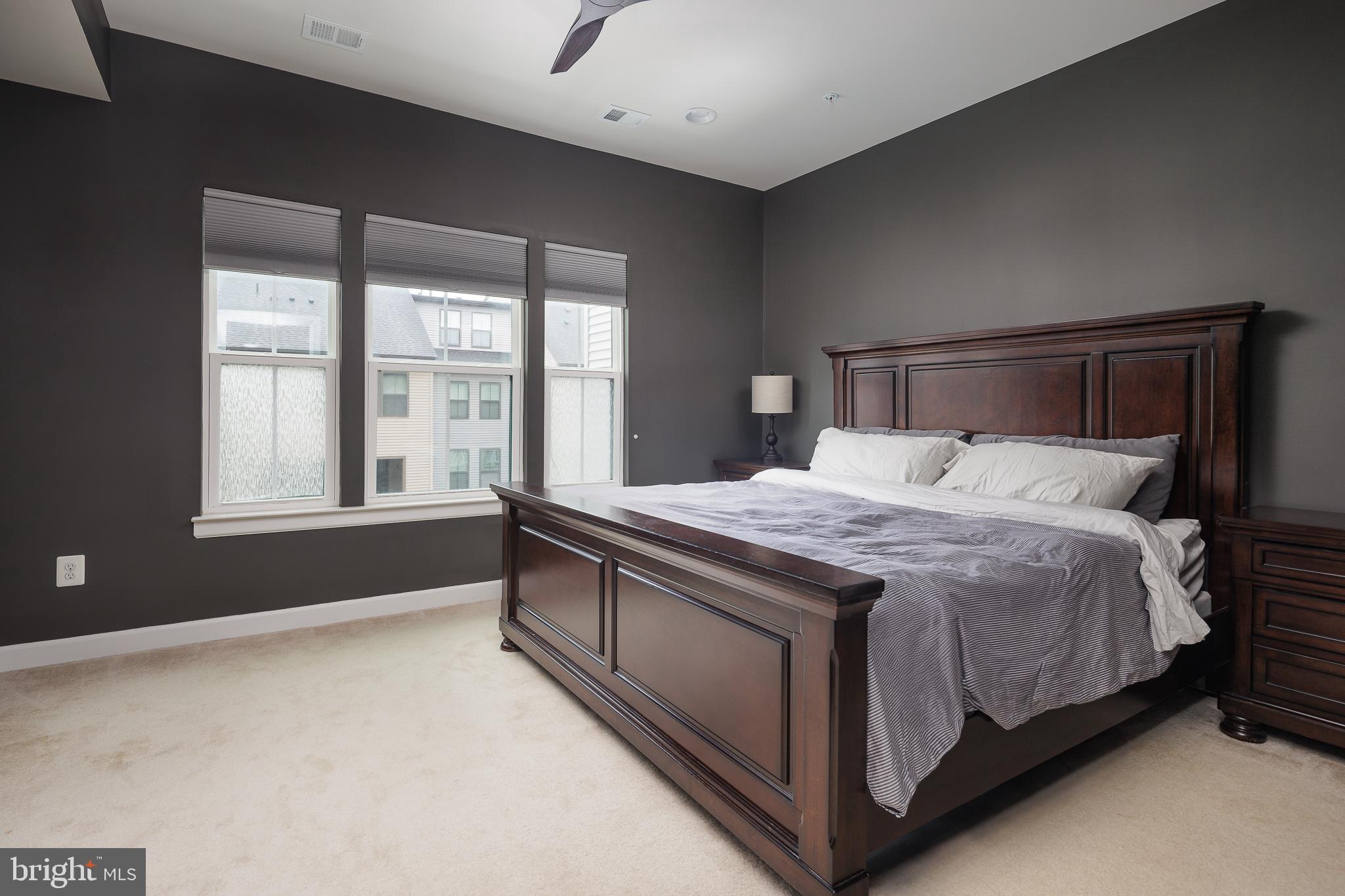 22355 Exe Square Ashburn, VA 20148 - Photo 13 of 65 a bed sitting in a spacious bedroom next to a window