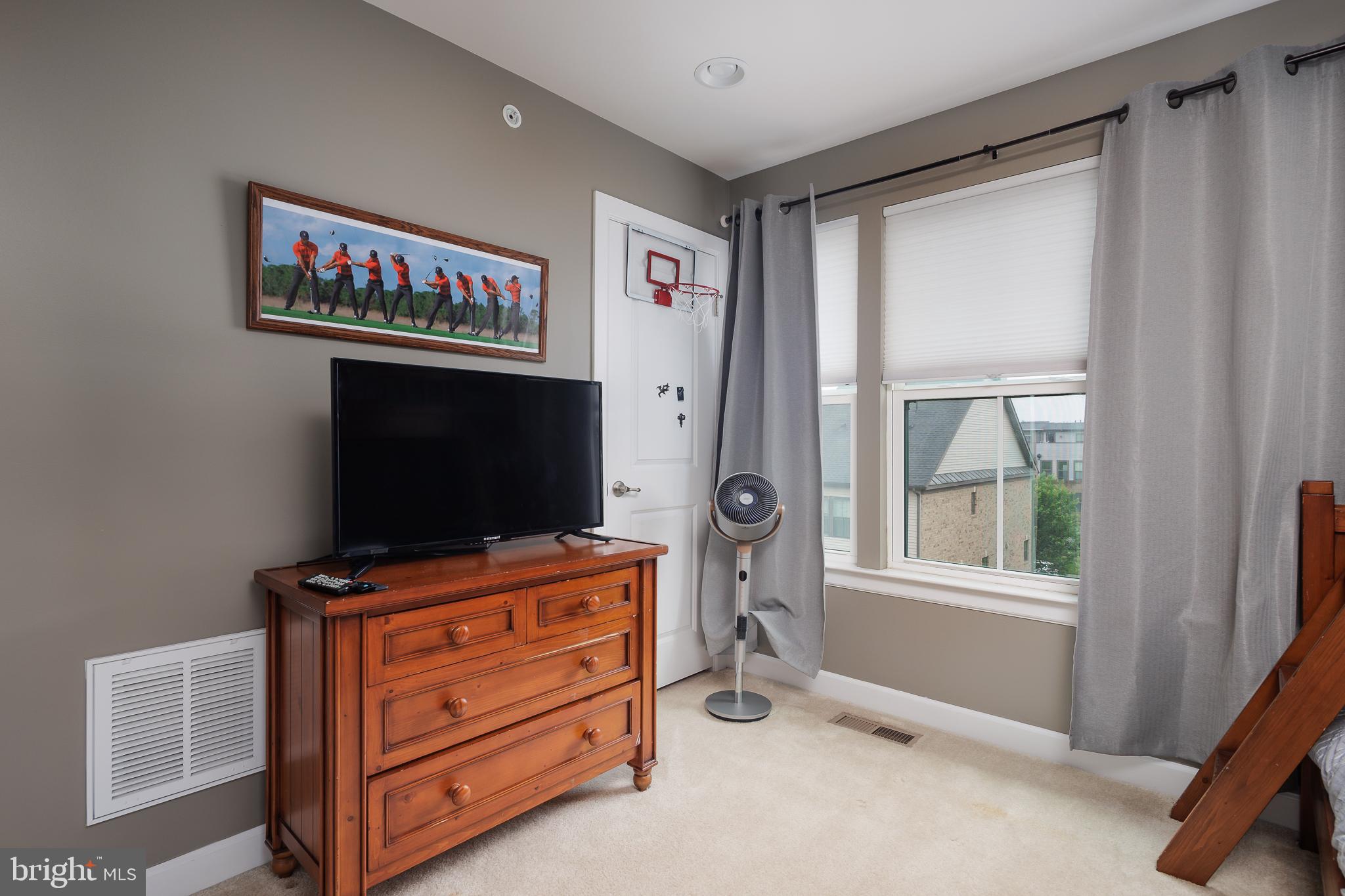 22355 Exe Square Ashburn, VA 20148 - Photo 21 of 65 a room with furniture and flat screen tv