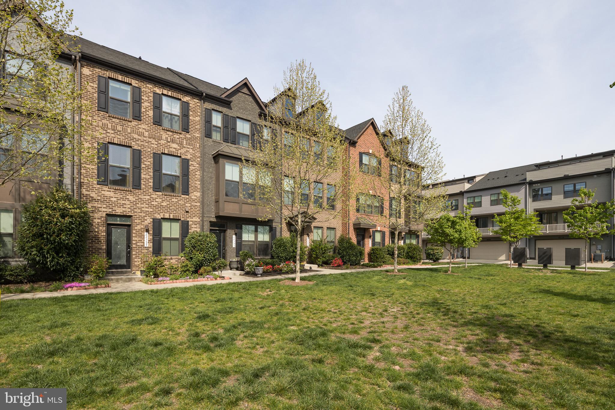 22355 Exe Square Ashburn, VA 20148 - Photo 29 of 65 a front view of a building with a yard